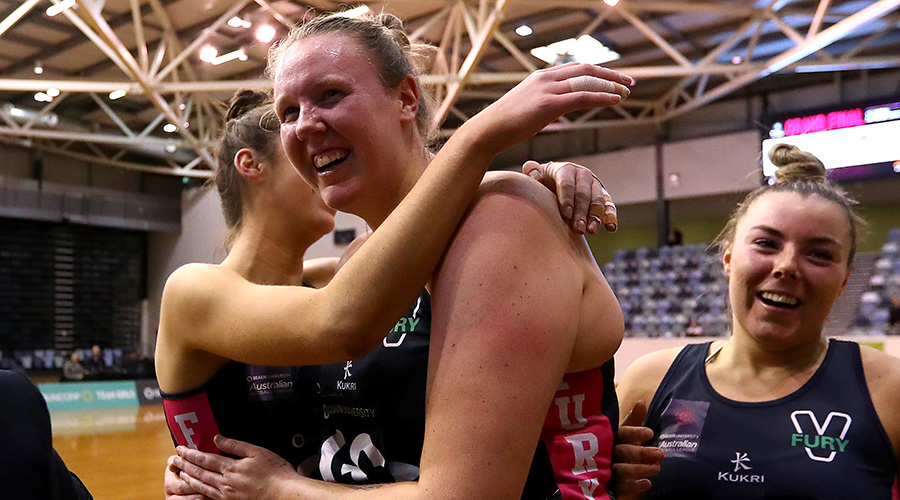Emma Ryde celebrates with her Victorian Fury teammates after their Australian Netball League victory