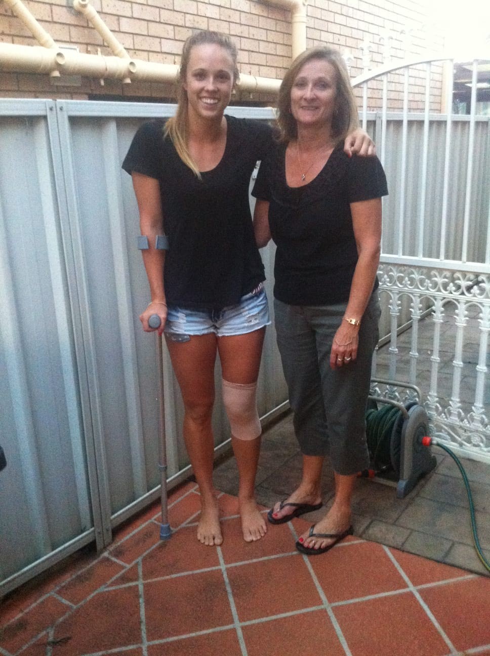 Paige Hadley with her mum after her knee injury. 