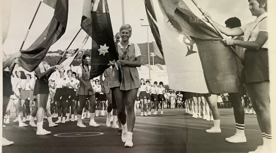 Australian captain, Gaye Teede carrying Australian flag through victory arch in Jamica. 