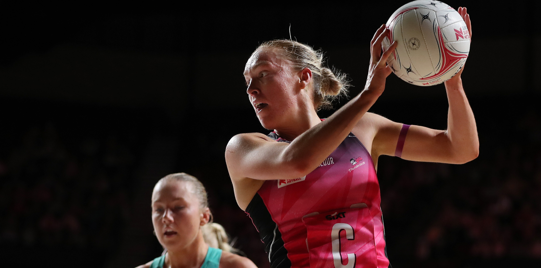 Hannah Petty controls a ball in front of Hannah Mundy