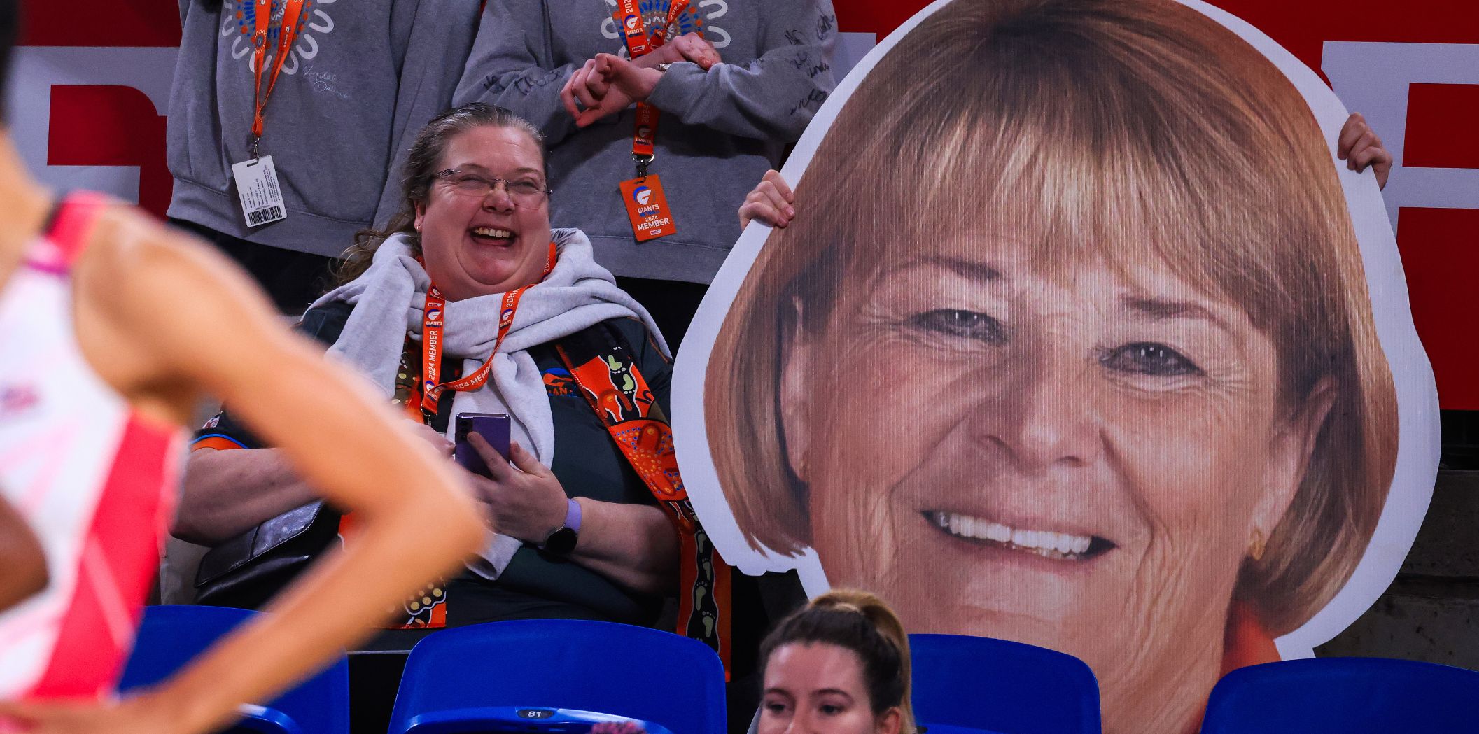 A fan sits next to a giant Fitzgerald image