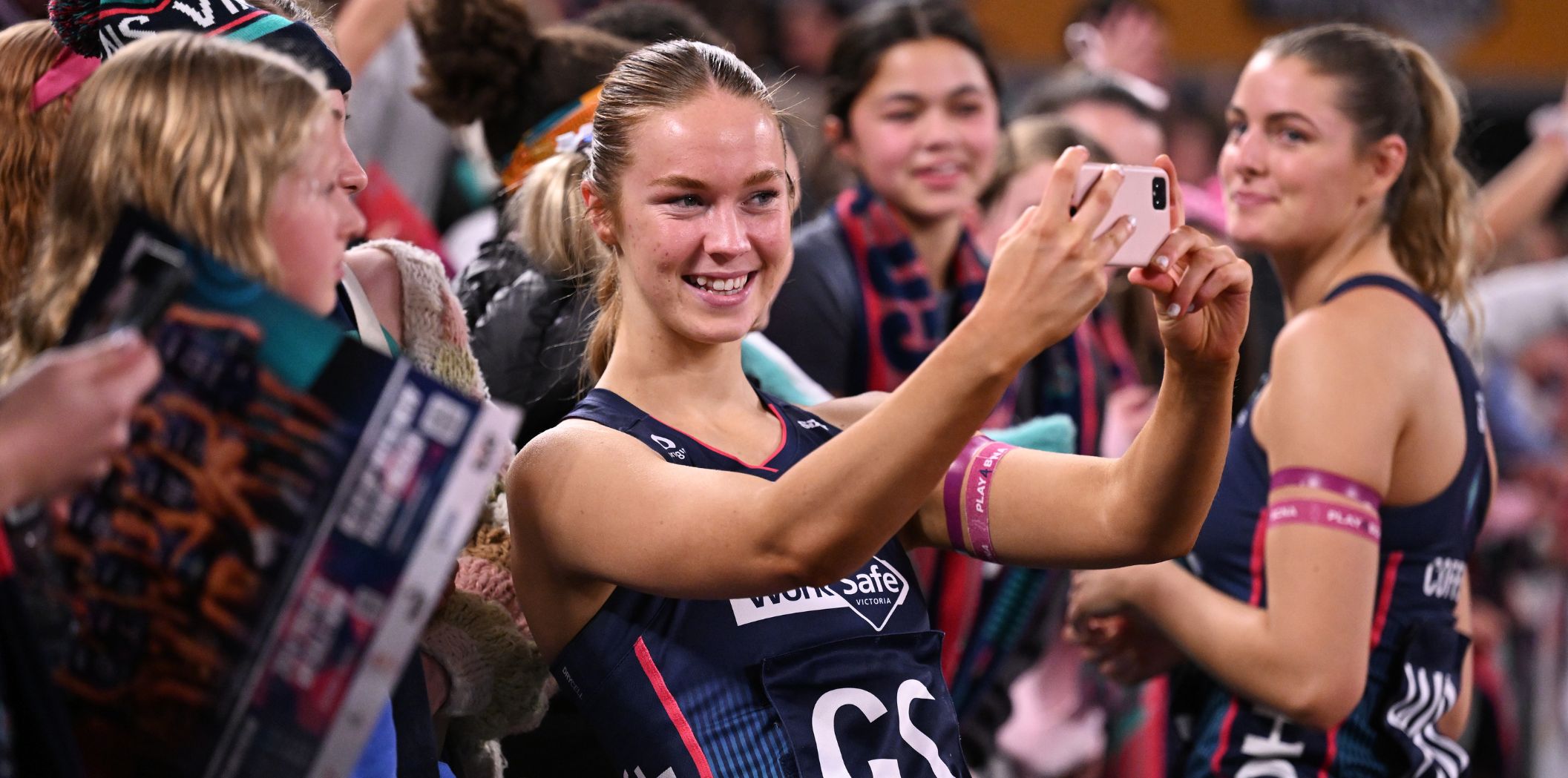 Emily Andrew takes a photo with some Vixens fans