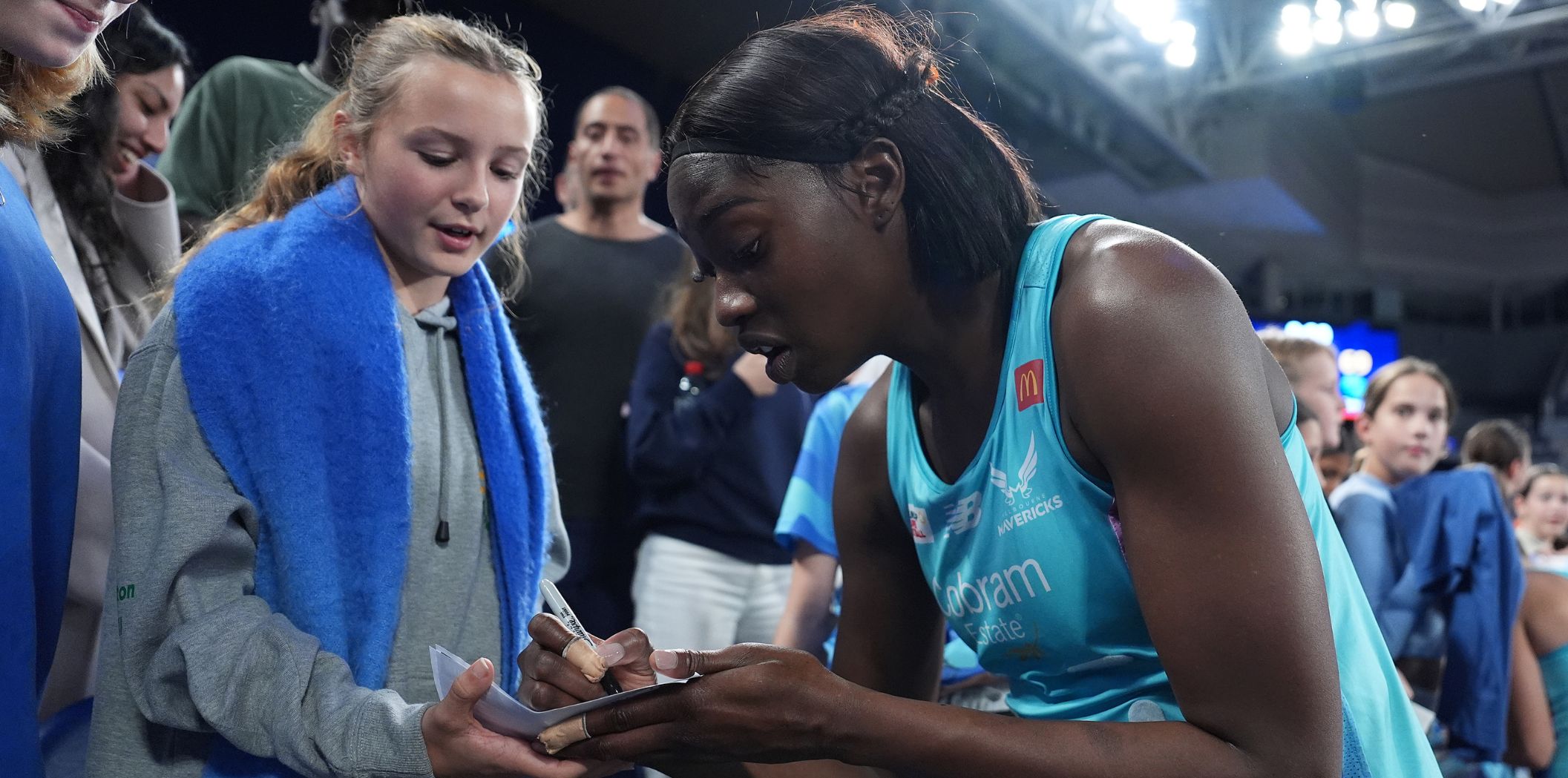 Shimona Jok signs an autograph