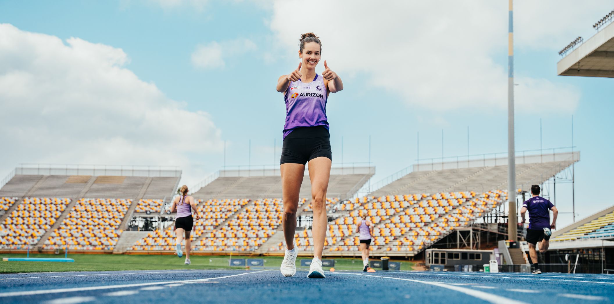 Emily Moore gives the camera a thumbs up after finishing a sprint