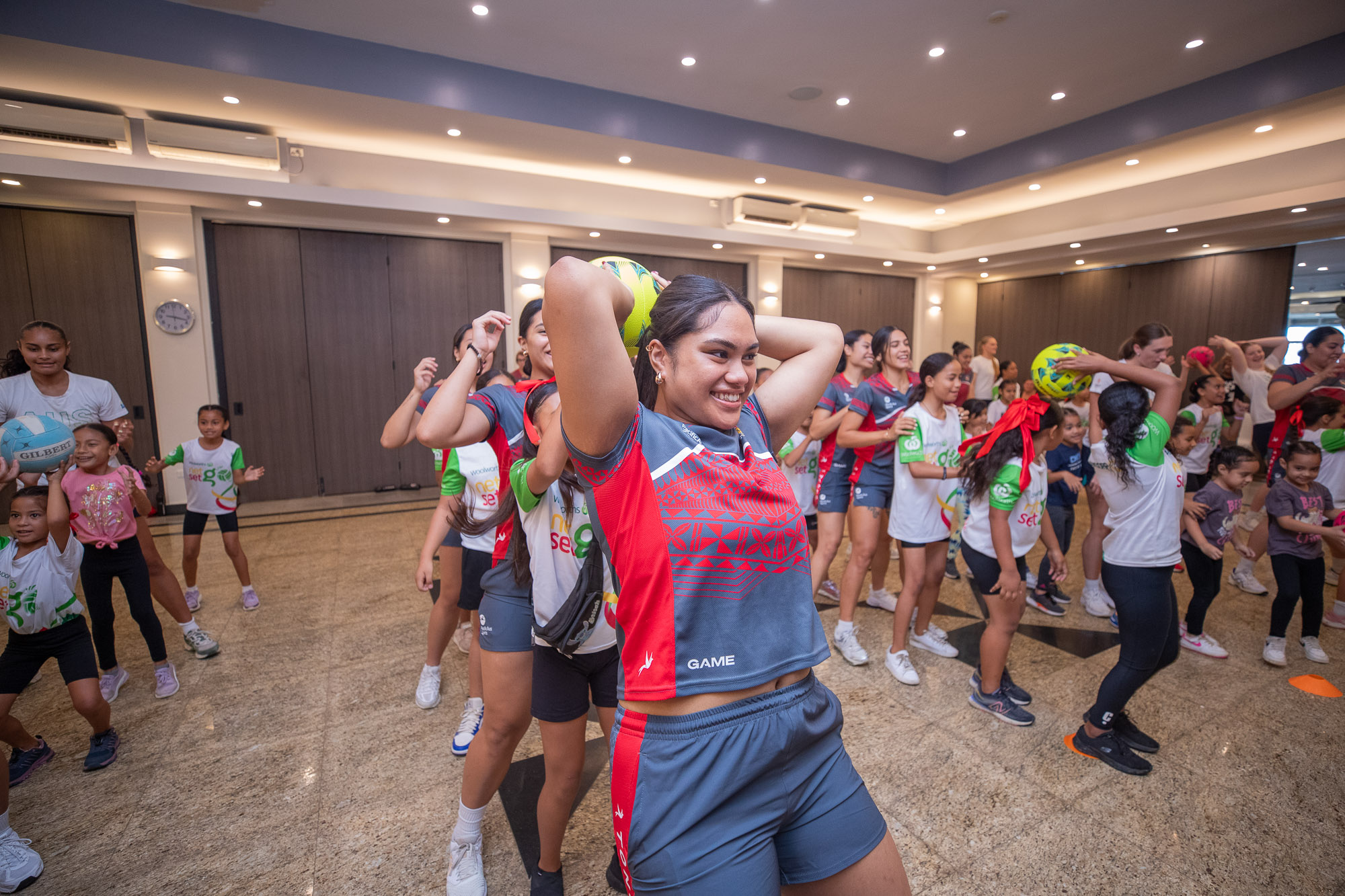 Athletes connected with young netballers during a community clinic as part of Tonga Netball Association's Kidsnet program. 