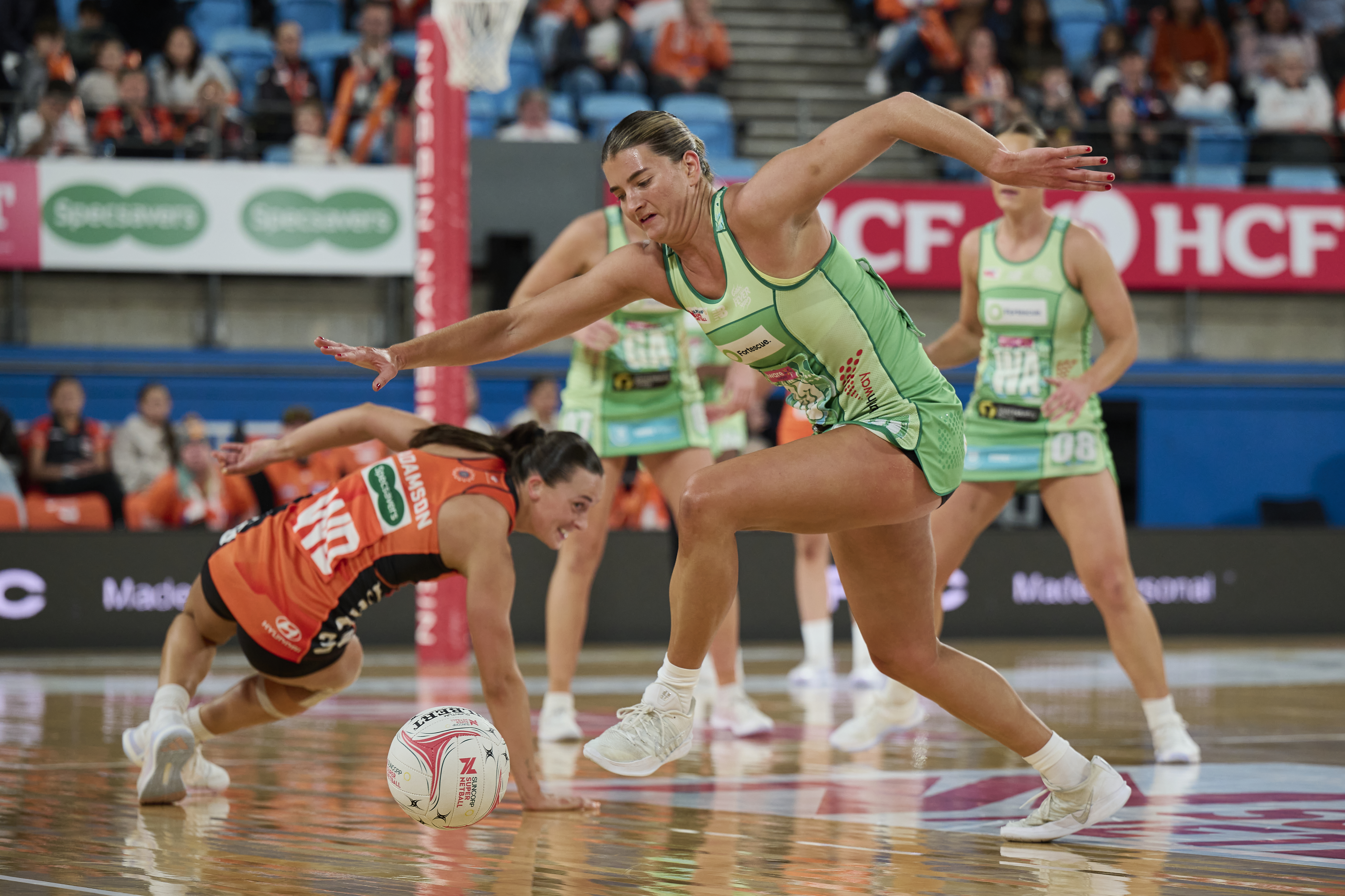 Williams and Adamson collide in a contest, fighting hard for the loose ball.